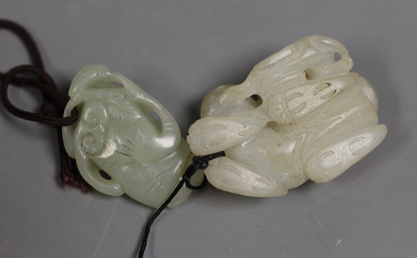 A Chinese pale celadon jade lion dog and cub and a similar figure of a boy, 19th/20th century